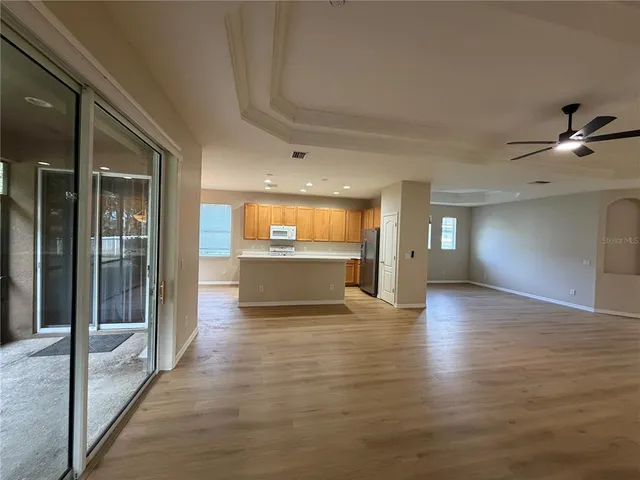 a large kitchen with stainless steel appliances a sink dishwasher stove and wooden cabinets