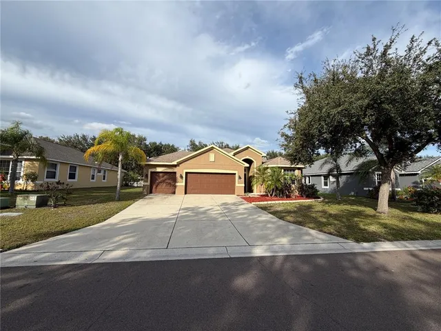 a front view of a house with a yard and garage