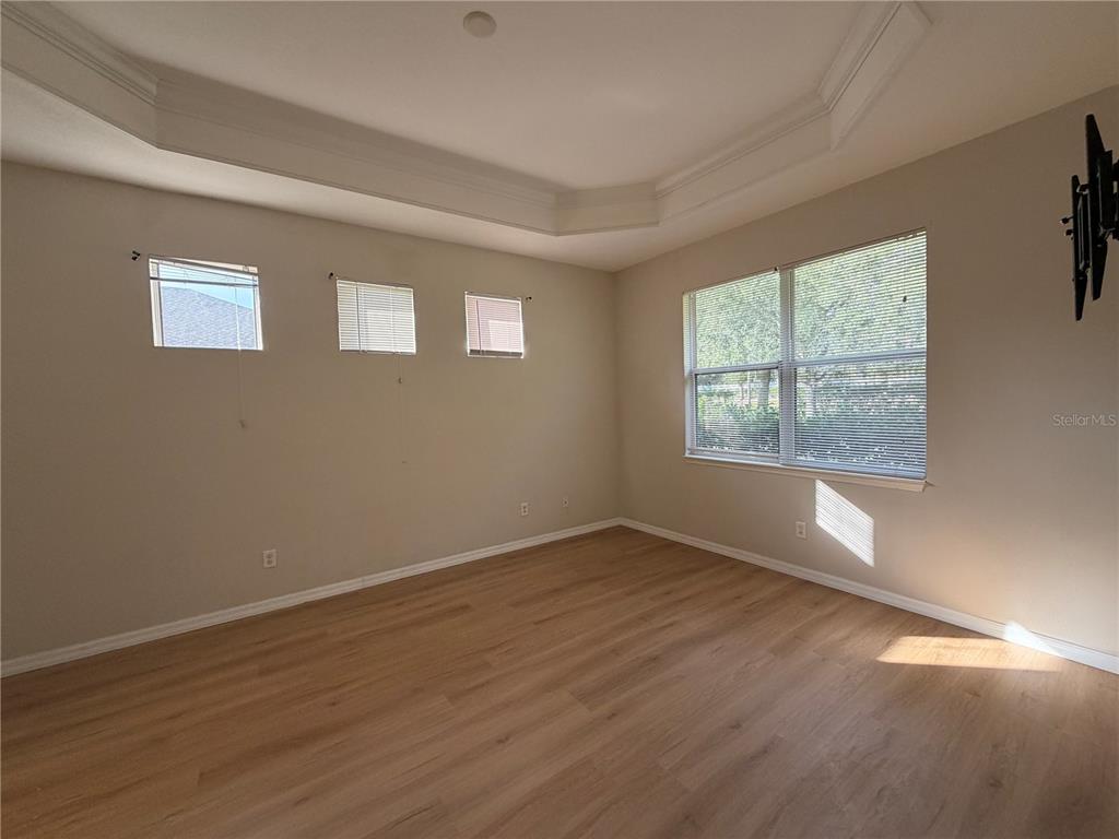 12418 24th Street East Parrish, FL 34219 - Photo 32 of 59 an empty room with wooden floor and windows