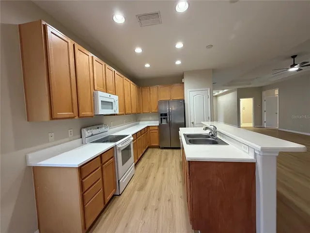 a view of a room with wooden floor