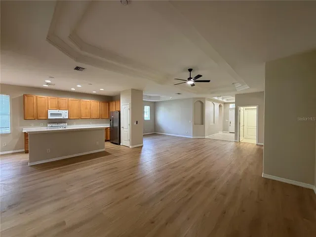a view of a room with wooden floor