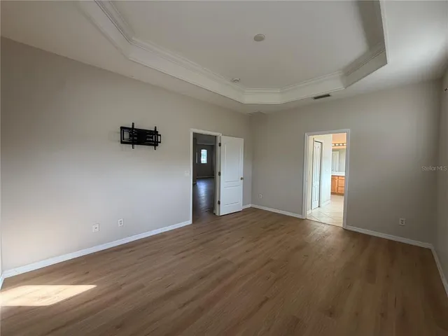 a white toilet sitting next to a white wall