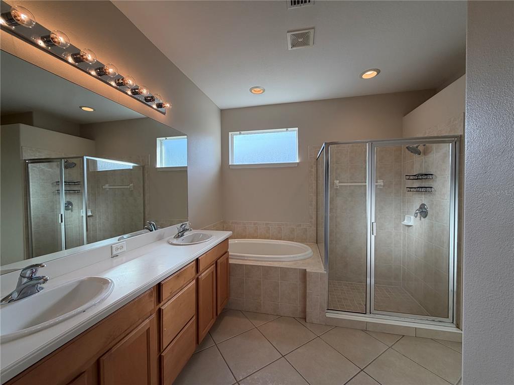 12418 24th Street East Parrish, FL 34219 - Photo 39 of 59 a bathroom with a sink double vanity and a mirror