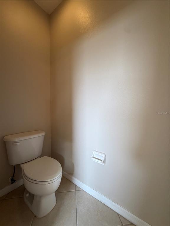 12418 24th Street East Parrish, FL 34219 - Photo 41 of 59 a white toilet sitting next to a white wall