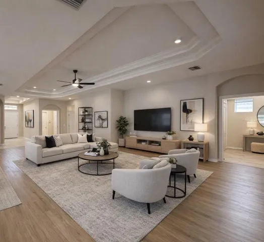 a living room with furniture flat screen tv and wooden floor