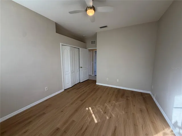 a view of an empty room and wooden floor