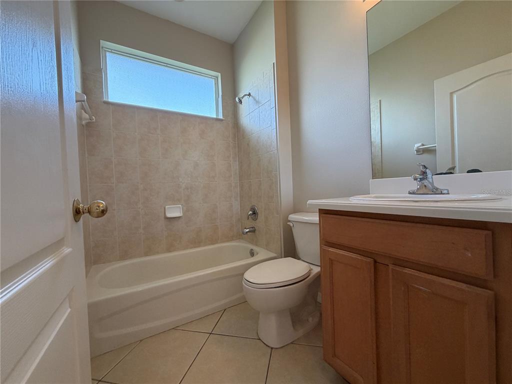 12418 24th Street East Parrish, FL 34219 - Photo 7 of 59 a bathroom with a sink a toilet and shower