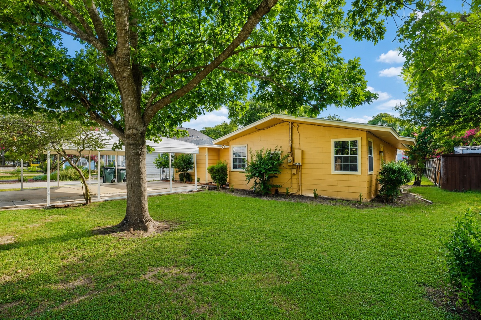 1508 Walnut Street Georgetown, TX 78626 - Photo 35 of 37 A well-maintained yard and carport complement this charming yellow residence.