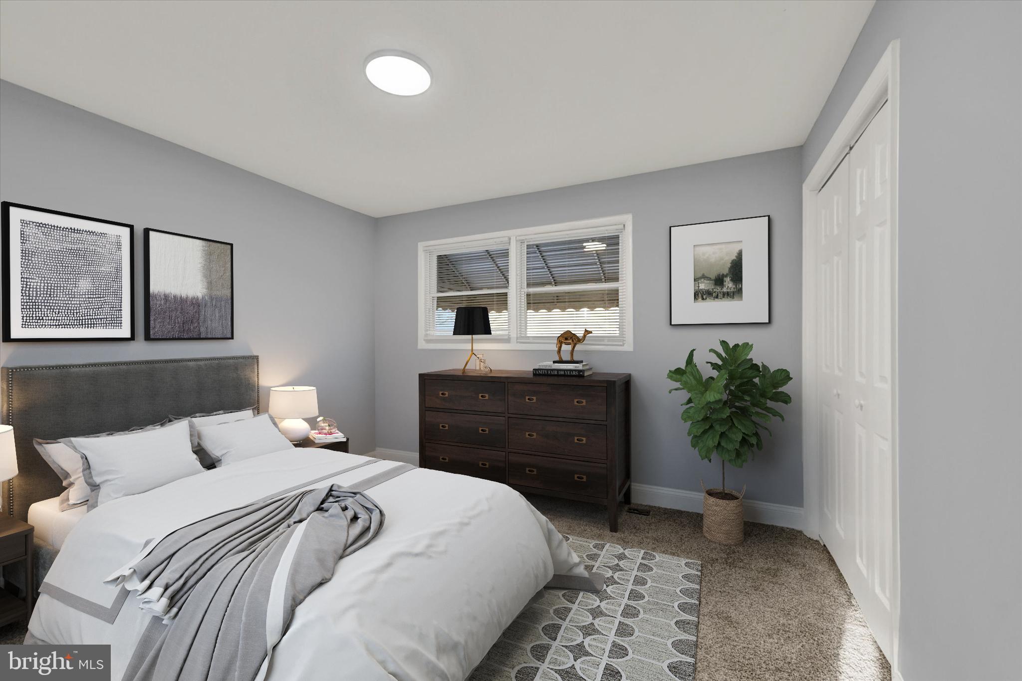 3105 Frisby Street Baltimore, MD 21218 - Photo 11 of 22 a bedroom with a bed and a potted plant