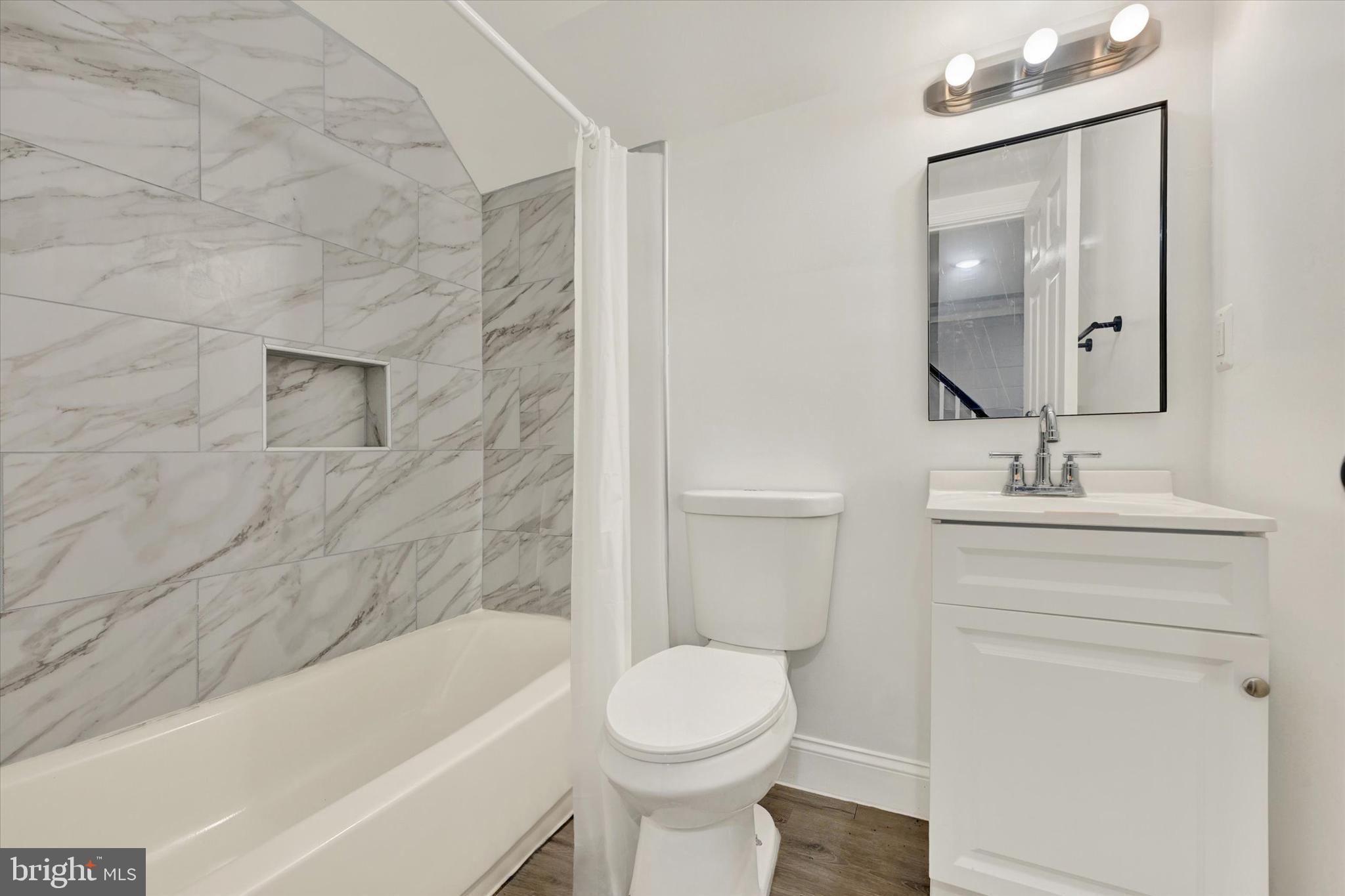 3105 Frisby Street Baltimore, MD 21218 - Photo 17 of 22 a bathroom with a sink toilet and bathtub