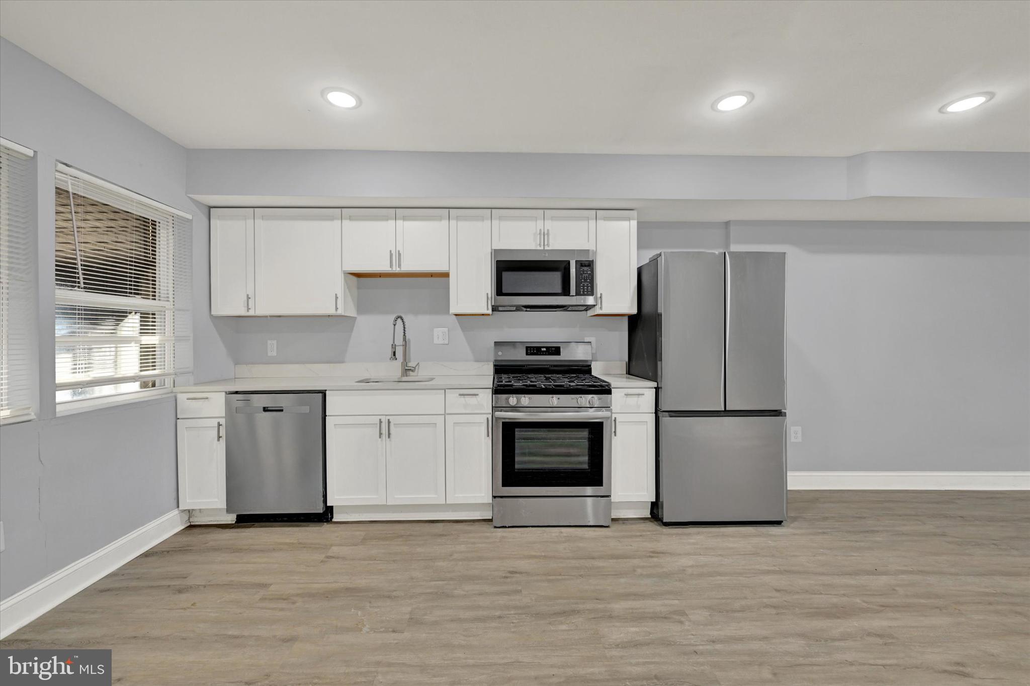 3105 Frisby Street Baltimore, MD 21218 - Photo 6 of 22 a kitchen with a refrigerator stove and microwave