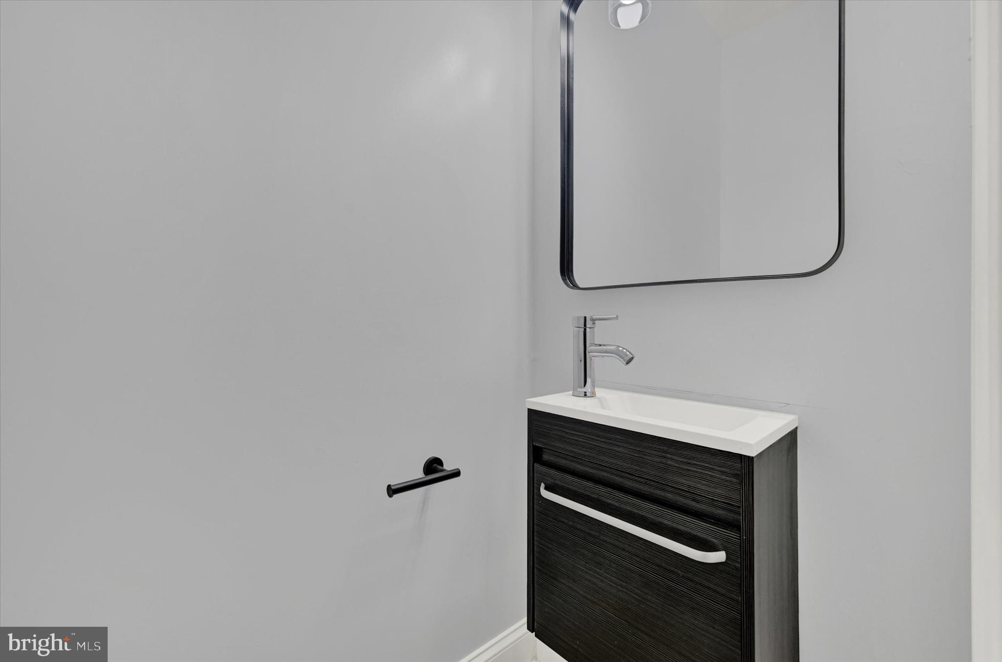 3105 Frisby Street Baltimore, MD 21218 - Photo 10 of 22 a bathroom with a sink and a mirror