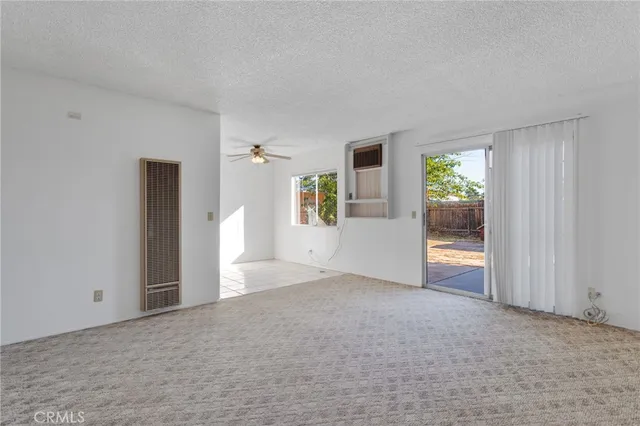a view of a big room with windows and cabinet
