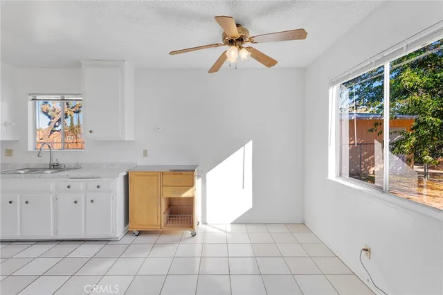 a view of a kitchen with wooden cabinets and a window