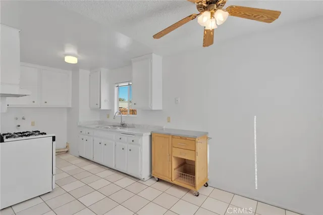 a spacious bathroom with a granite countertop sink a mirror and a bathtub