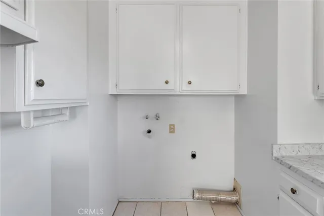a view of bathroom with white cabinets