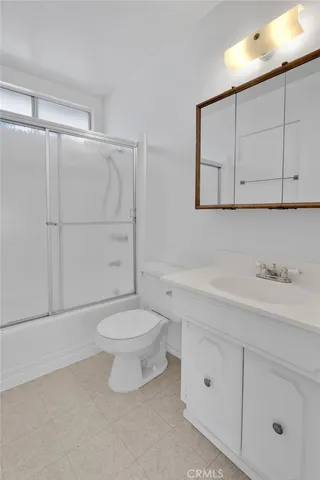 a bathroom with a toilet a sink a vanity and mirror