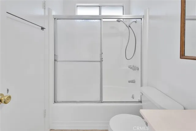 a bathroom with a shower and a toilet sink