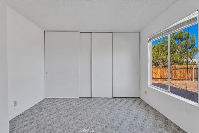 a view of an empty room and closet area
