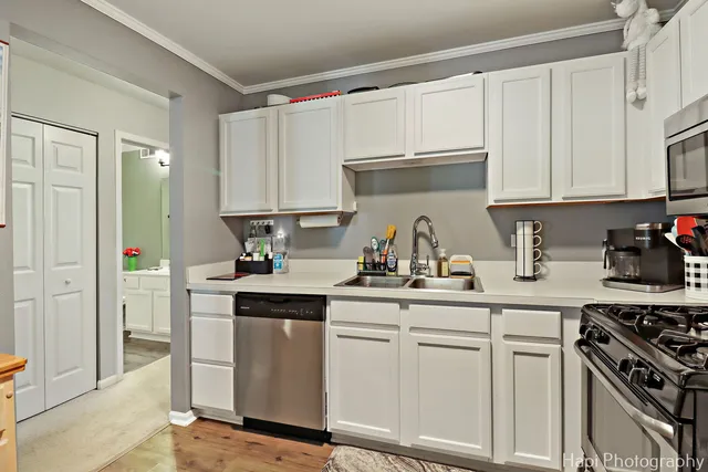 a kitchen with white cabinets and white appliances