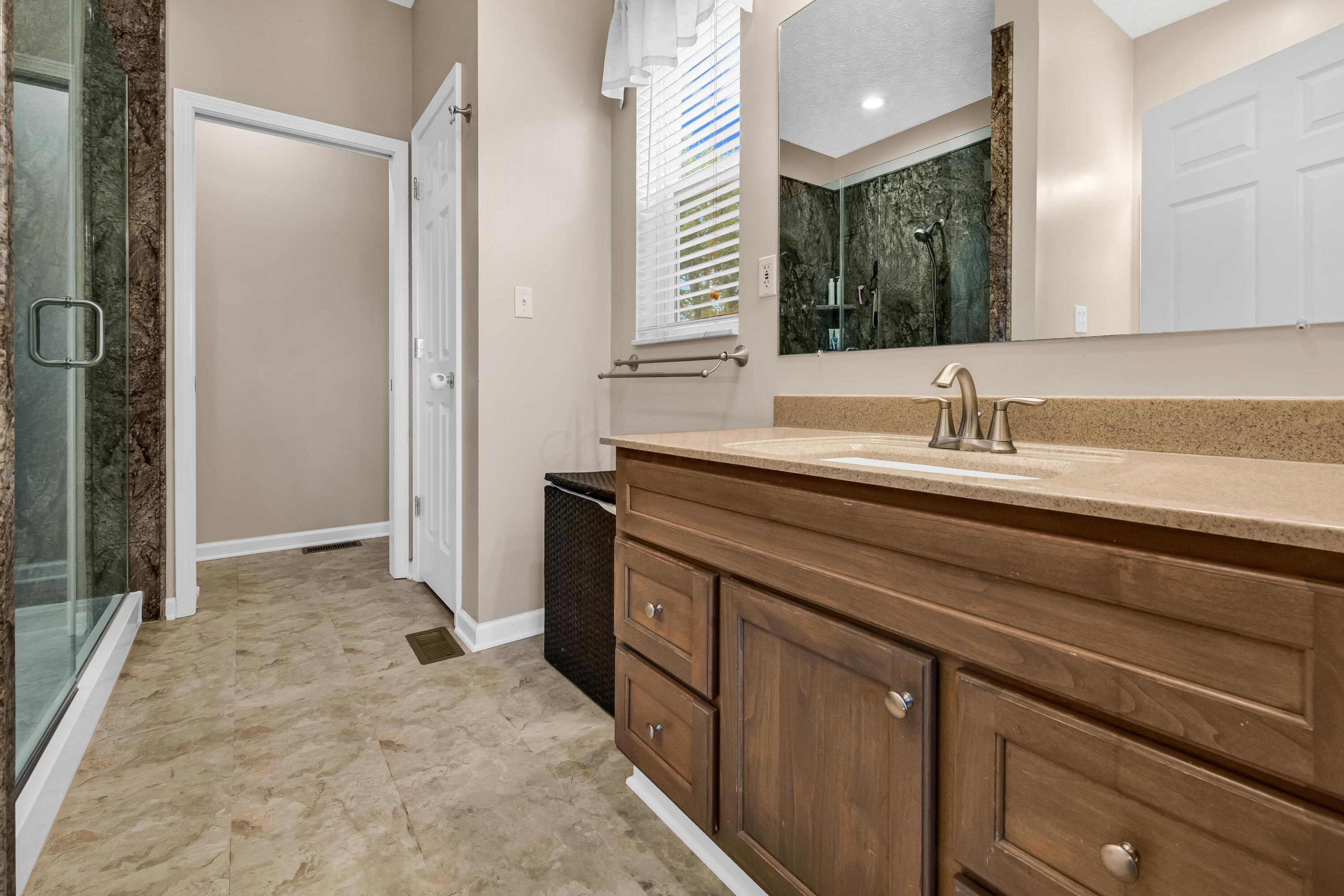 14396 Blamer Road Johnstown, OH 43031 - Photo 23 of 48 • New neutral vinyl flooring
• Ivory painted walls
• Shower stall with cultured
marble surround & glass
door
• Ceiling exhaust
• His & hers vanity with single
bowl, cultured marble
sinktops
• (2) 4 bulb wall lights
• Linen closet
• 2” blinds