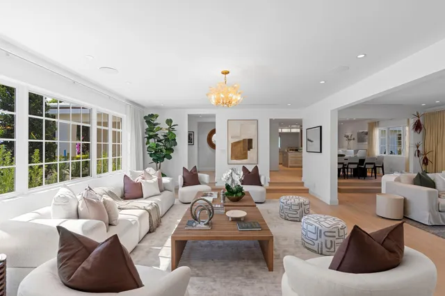 a kitchen that has a sink a stove and cabinets