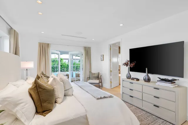 a living room with patio furniture and a floor to ceiling window