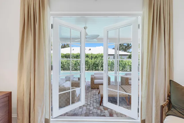 a bedroom with a bed and a large window