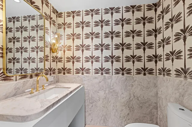 a view of a patio with couches chairs potted plants and a palm tree