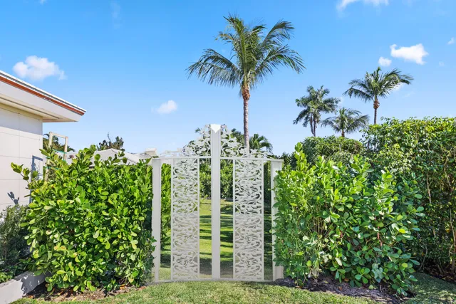 a front view of a house with porch and furniture