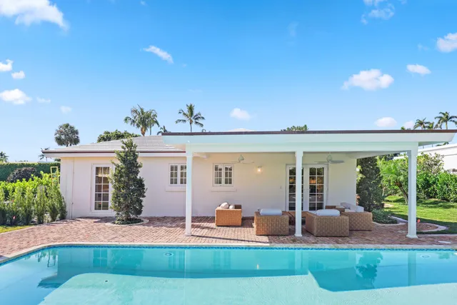 a swimming pool with outdoor seating yard