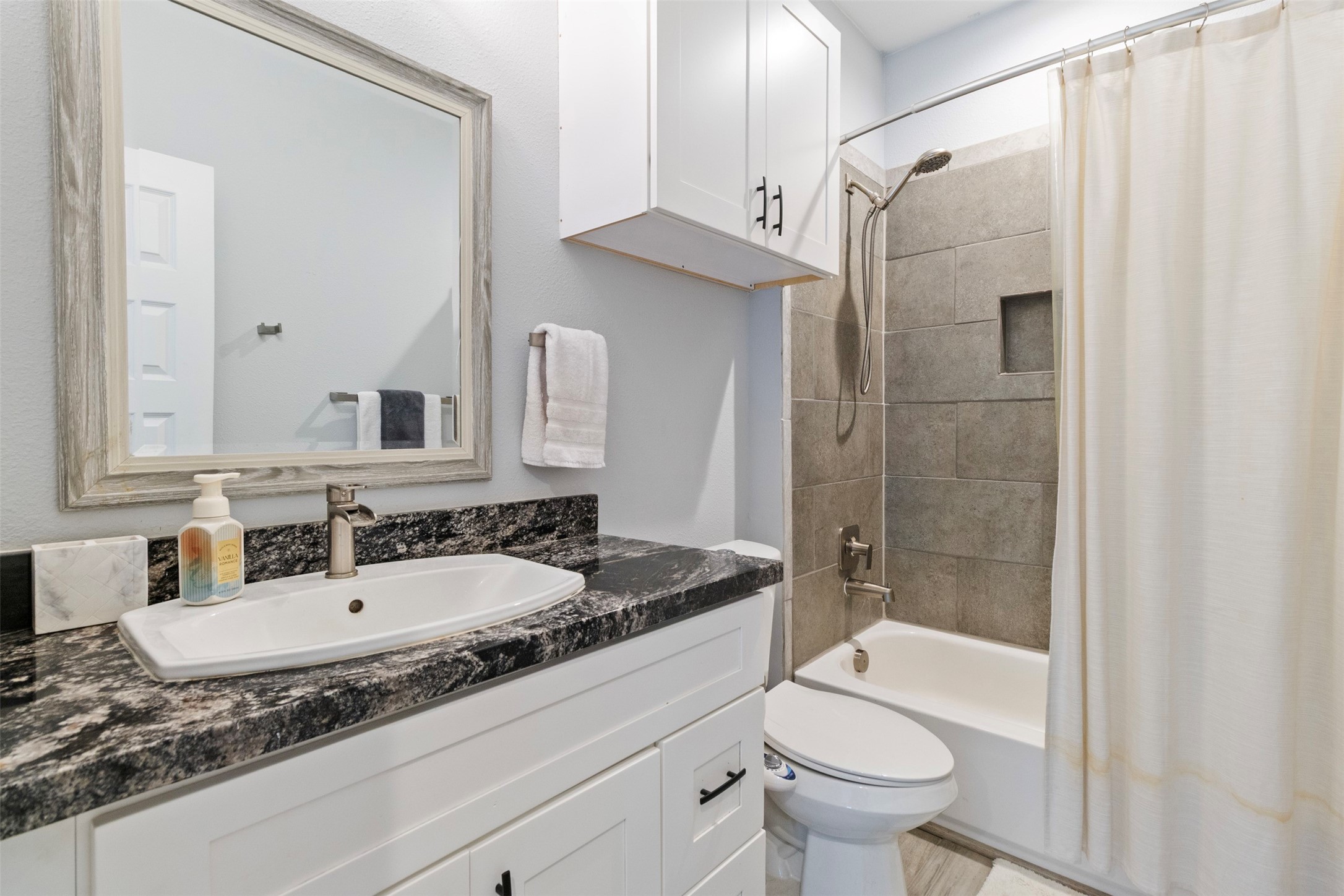 6706 Lozier Street Houston, TX 77021 - Photo 9 of 32 a bathroom with a granite countertop sink toilet and shower