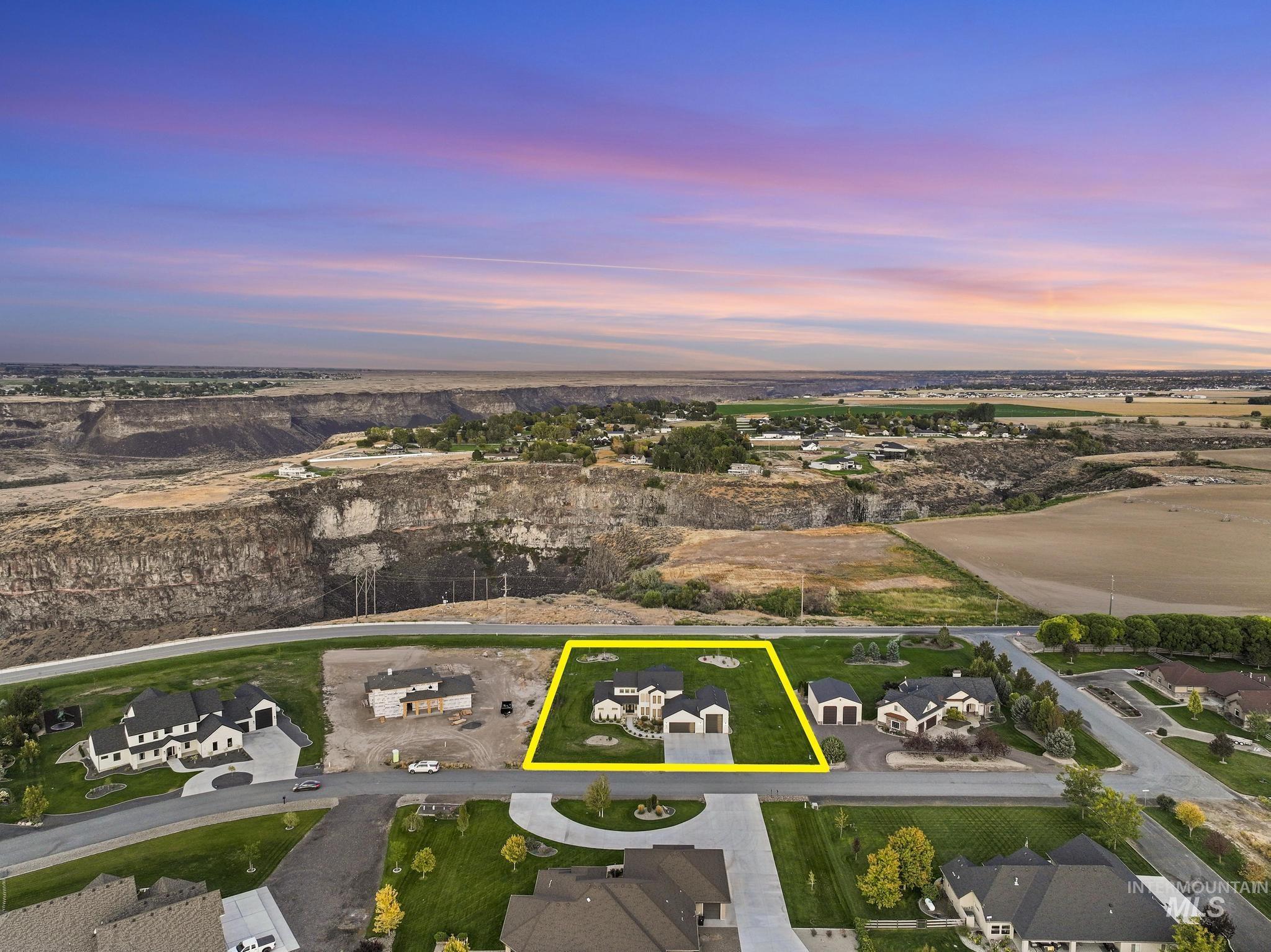 Single-story residence with a two-car garage, manicured lawn, and paved driveway