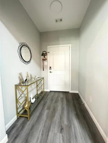 a view of a room with wooden floor and furniture