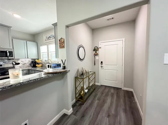 a kitchen with cabinets a sink and appliances