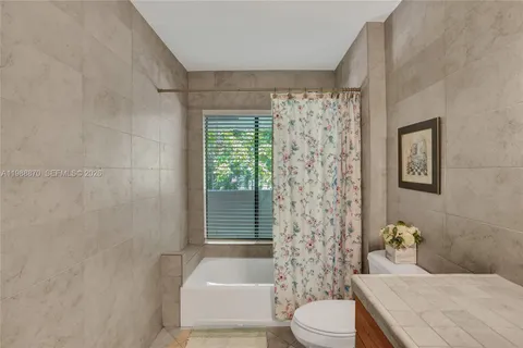 a bathroom with a toilet and shower