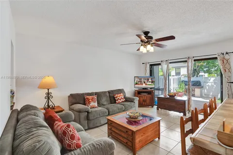 a living room with furniture a rug and a chandelier
