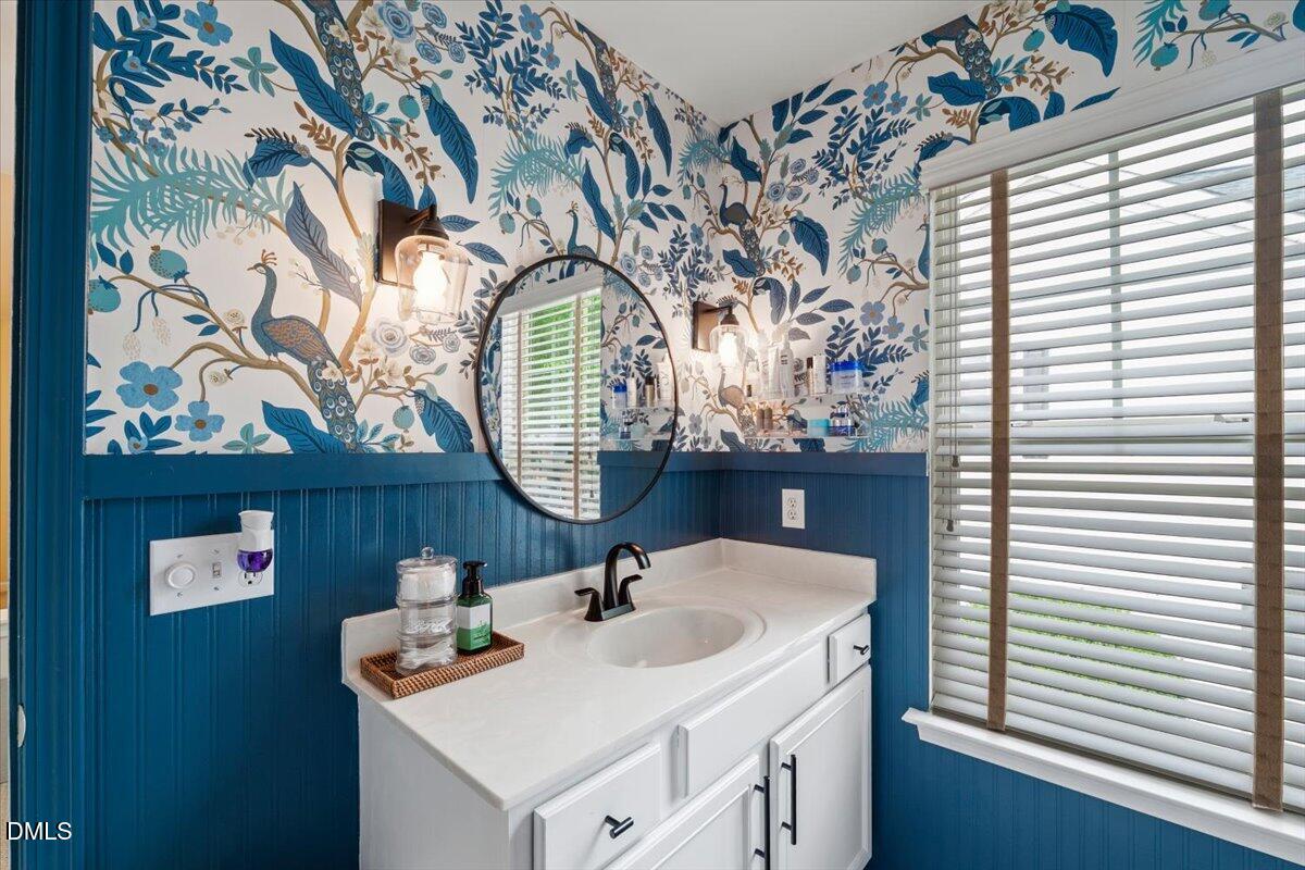 8449 Central Drive Raleigh, NC 27613 - Photo 28 of 38 a bathroom with a sink and a mirror