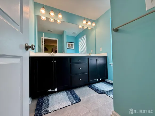 a bathroom with a double vanity sink and a mirror