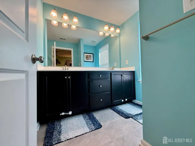 a bathroom with a double vanity sink and a mirror