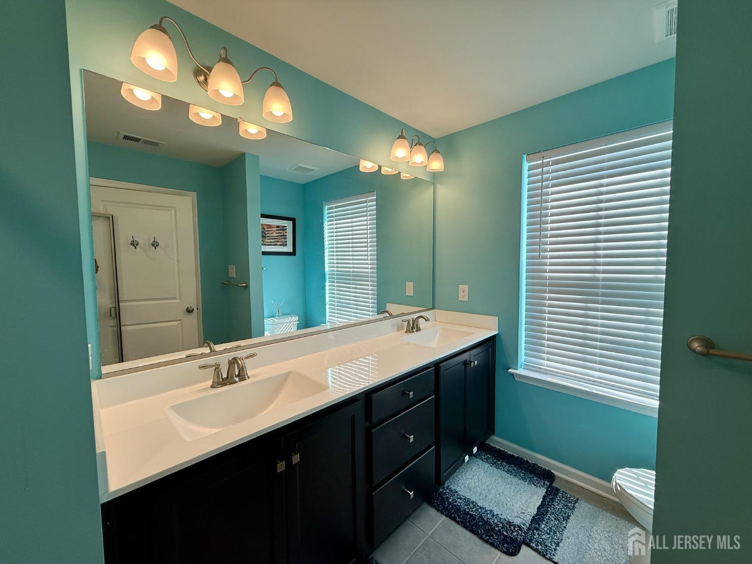301 Matutina Road Monroe Township, NJ 08831 - Photo 20 of 42 a bathroom with a double vanity sink and a mirror