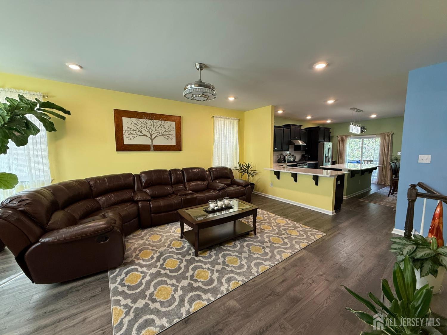 301 Matutina Road Monroe Township, NJ 08831 - Photo 26 of 42 a living room with furniture and a dining table with wooden floor