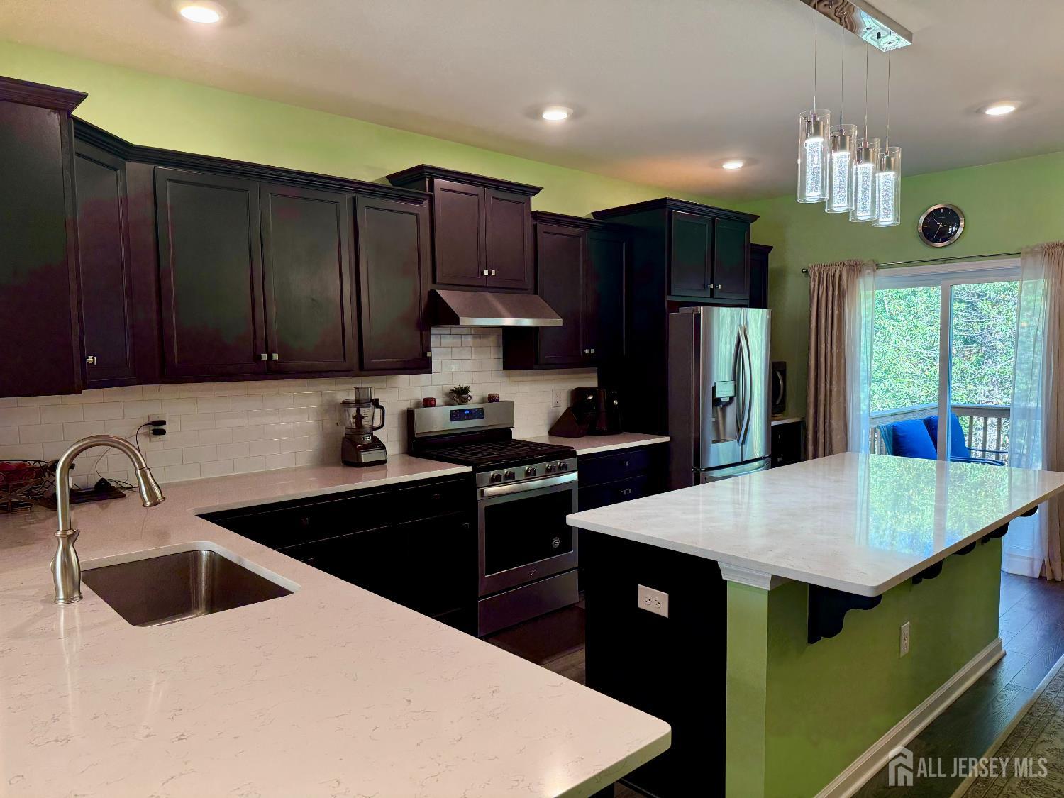301 Matutina Road Monroe Township, NJ 08831 - Photo 31 of 42 a kitchen with kitchen island granite countertop a sink a counter top space and stainless steel appliances