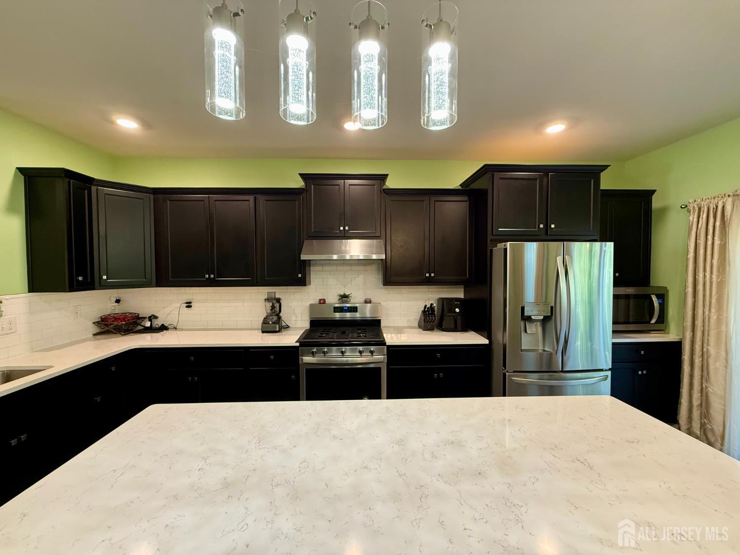 301 Matutina Road Monroe Township, NJ 08831 - Photo 32 of 42 a kitchen with refrigerator cabinets and furniture