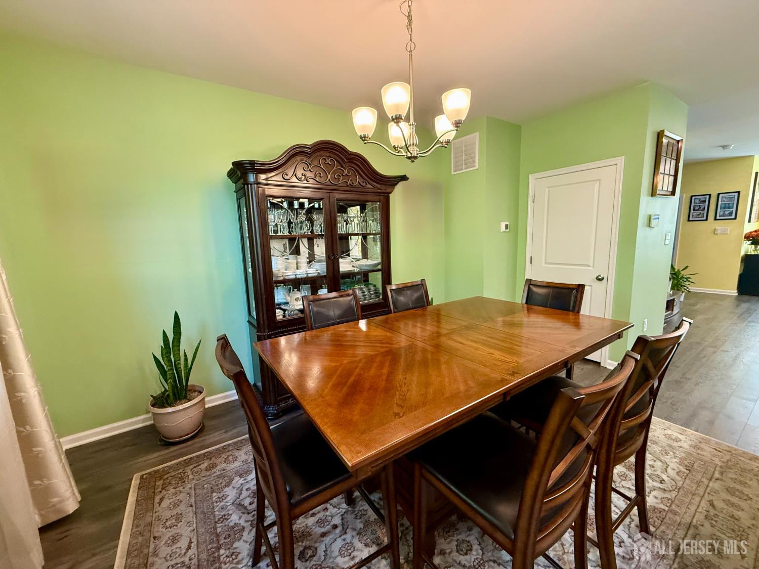 301 Matutina Road Monroe Township, NJ 08831 - Photo 33 of 42 a view of a dining room with furniture and wooden floor