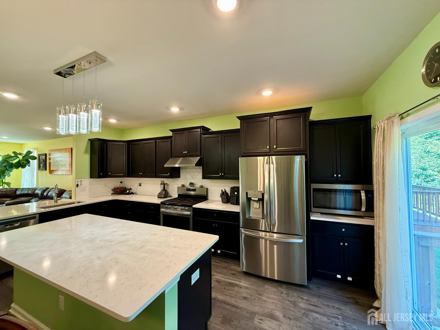 301 Matutina Road Monroe Township, NJ 08831 - Photo 36 of 42 a kitchen with kitchen island a sink stainless steel appliances and refrigerator