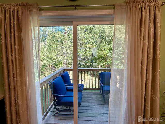 a view of balcony with wooden floor and fence