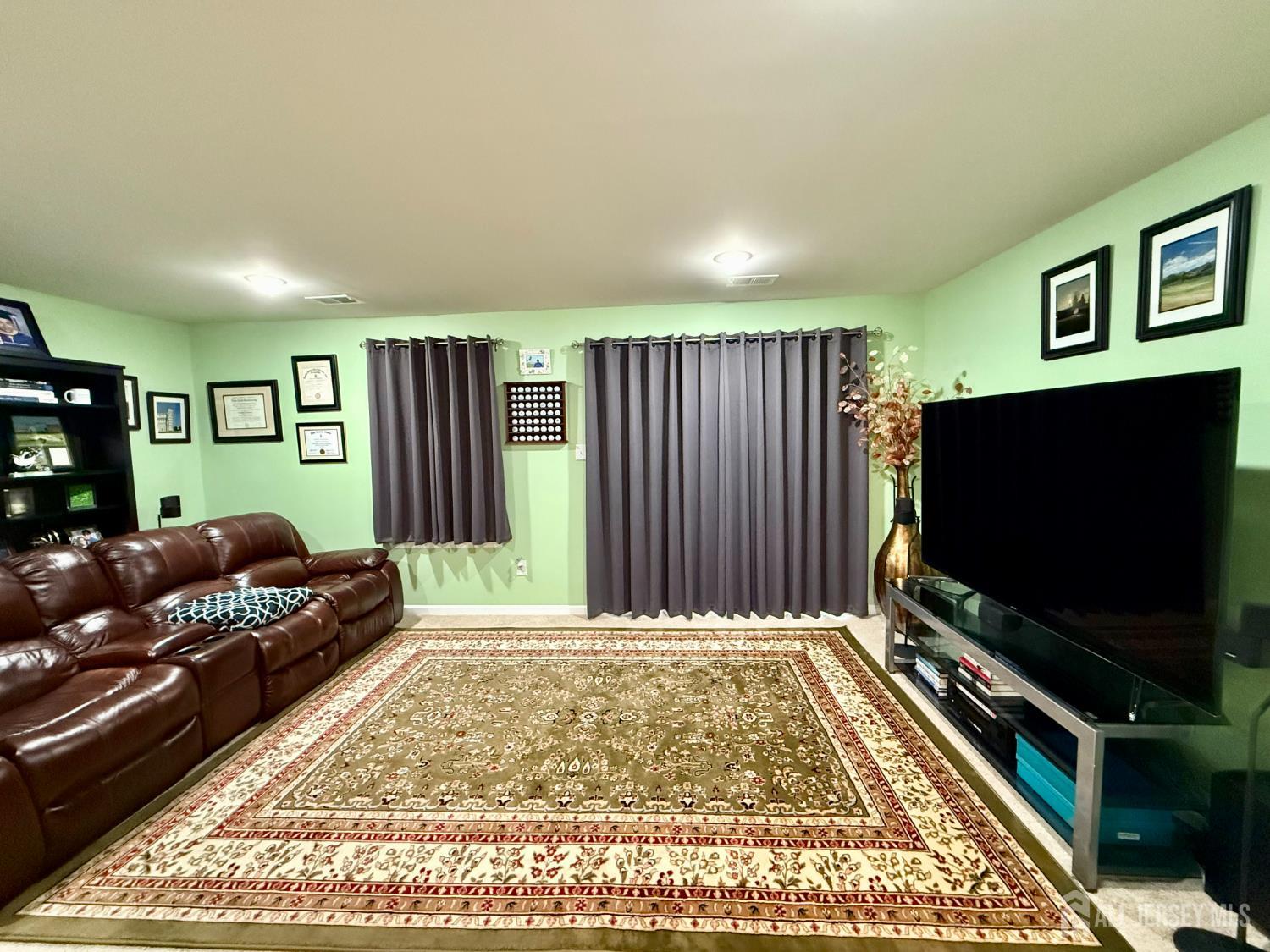 301 Matutina Road Monroe Township, NJ 08831 - Photo 42 of 42 a living room with furniture and a flat screen tv