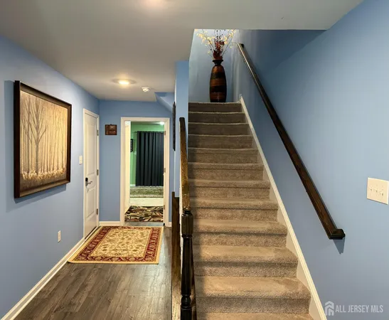 a view of entryway and hall with wooden floor