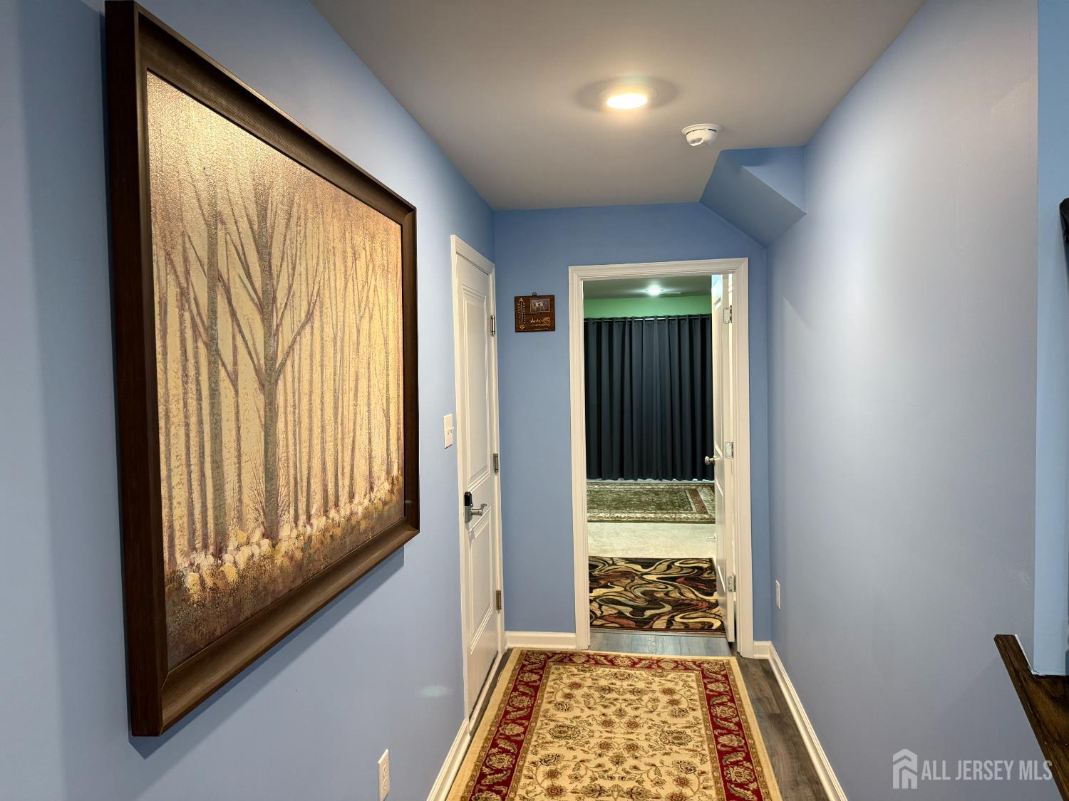 301 Matutina Road Monroe Township, NJ 08831 - Photo 6 of 42 a view of a hallway with wooden floor and a bedroom